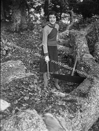 WOMAN AT SAW IN FOREST